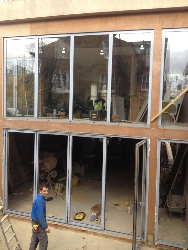 Aluminium bi-fold doors with two-storey glazing in Nine Elms
