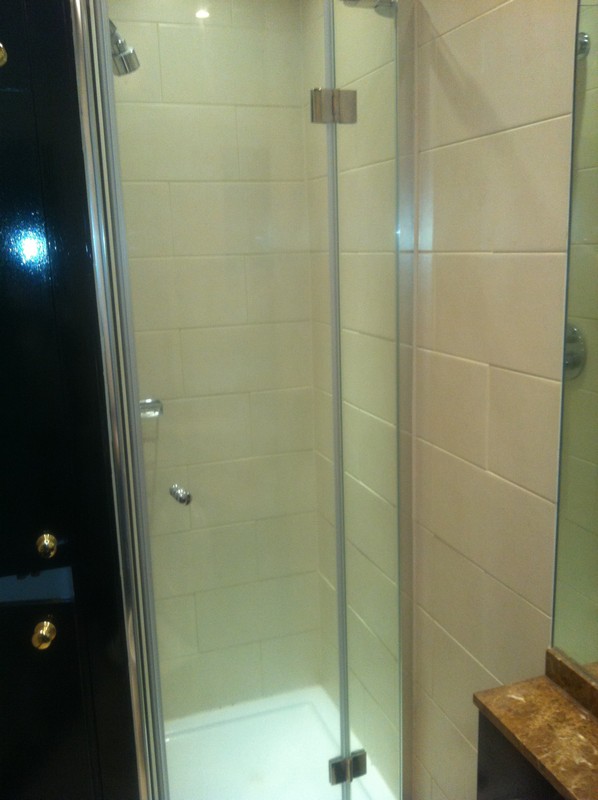 Frameless glass shower enclosure with chrome fittings in Nine Elms
